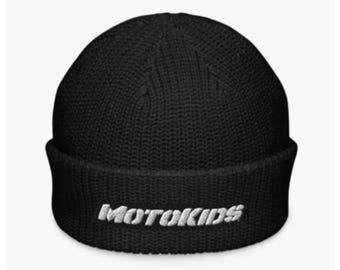 May include: Black knit beanie with a folded brim. The white embroidered text "MOTOKIDS" is centered on the front. The hat is made of a ribbed knit material.
