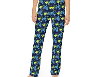 May include: Navy blue pajama pants with a repeating pattern of blue motorcycles and green paint splatters. The pants have a relaxed fit and a straight leg. The fabric appears to be soft and comfortable.