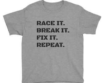 May include: Gray youth t-shirt with black text that reads "RACE IT. BREAK IT. FIX IT. REPEAT."
