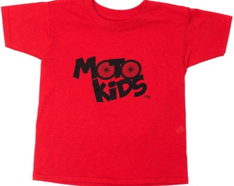 May include: Red short-sleeved t-shirt with a black graphic of a bicycle wheel and the text "Moto Kids" with a trademark symbol.