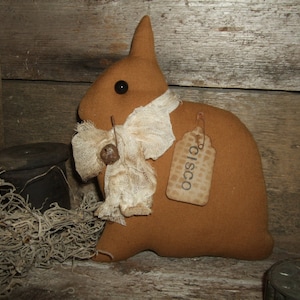 May include: A brown fabric bunny with a white fabric bow and a brown tag that says "CISCO".
