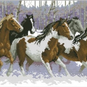 May include: A group of five horses running through a snowy forest. The horses are brown, black, and white with brown and white markings. The horses are running in a line, with the lead horse in the front and the other horses following behind.