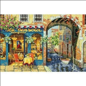 May include: A painting of a cafe called "La Pensola" in Venice, Italy. The cafe has a yellow facade with red and white striped awnings. There are tables and chairs set up outside the cafe, and a canal with a small boat is visible in the background.