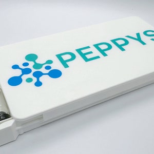 May include: White plastic case with a teal blue logo that says "PEPPHYS" and a small clear vial inside.