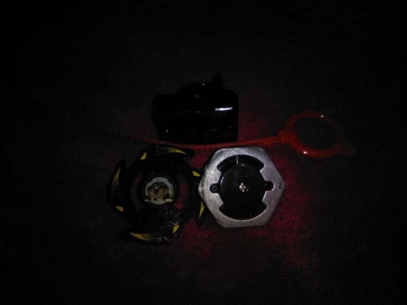 May include: A black and yellow spinning top toy with a silver and black base, a black launcher, and a red pull string. The toy is designed for competitive play and features a unique design.