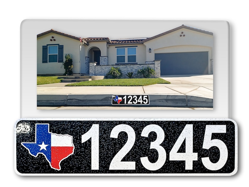 May include: A black and white house number sign with a Texas state outline in red, white, and blue. The number 12345 is printed in white on a black background. The sign is made of metal and has a textured surface.
