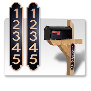 May include: Two black and gold vertical house number signs with the numbers 12345 on each sign. A black mailbox with a red flag is mounted on a wooden post with a smaller vertical house number sign with the numbers 12345.