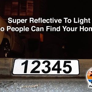 May include: A white reflective house number sign with black numbers "12345" on a curb. The sign is illuminated by a car's headlights. The text "Super Reflective To Light So People Can Find Your Home." is above the sign. The text "Curb-N-Sign" is below the sign.