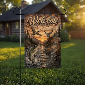 May include: A rectangular garden flag featuring the word Welcome in a script font at the top. The scene depicts a sunset over a river with a jumping bass fish in the foreground, a deer standing on the bank, and a mallard duck flying above.