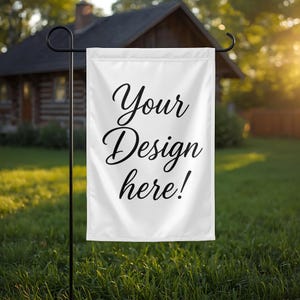 May include: A white rectangular garden flag hanging from a black metal stand. The flag features the black cursive text Your Design here! printed in the center. The fabric is smooth and opaque, suspended by a horizontal bar at the top.
