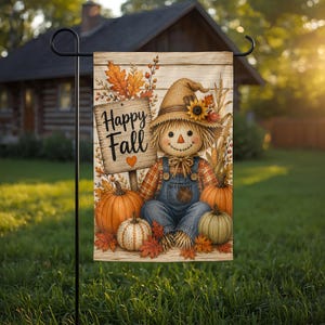 May include: A rectangular garden flag featuring a scarecrow wearing a burlap hat and blue denim overalls, sitting among orange and green pumpkins. A wooden sign with the text Happy Fall and a small orange heart is displayed next to the scarecrow.