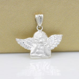 May include: Silver angel pendant charm with detailed wings and a cherub face.