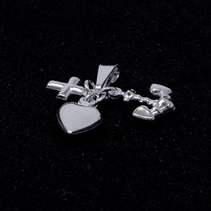 May include: Silver charm necklace with a heart, cross, and anchor pendant. The charms are connected by a delicate chain.
