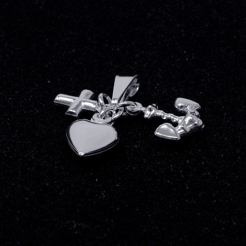 May include: Silver charm necklace with a heart, cross, and anchor pendant. The charms are connected by a delicate chain.
