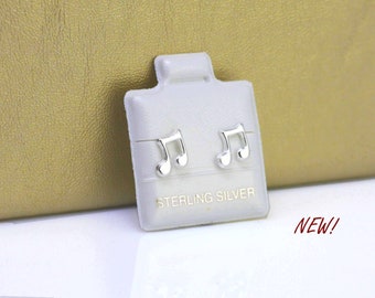 May include: A pair of sterling silver musical note earrings on a white display card. The card has the words "Sterling Silver" printed on it.