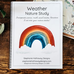 May include: A spiral-bound book titled "Weather Nature Study" with a watercolor rainbow illustration. The cover includes text about incorporating science, math, and art. The book is on a wooden surface with a partially visible book titled "Rainbows".