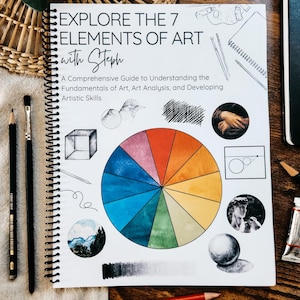 Peut inclure: Un guide d'art à spirales intitulé "Explorez les 7 éléments de l'art avec Steph". La couverture présente un cercle chromatique, des illustrations et du texte. Des crayons, un pinceau et des tubes de peinture sont disposés autour du livre sur une surface en bois.
