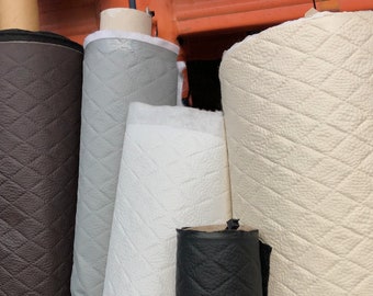 May include: Five rolls of fabric with a diamond pattern. The rolls are in various colors, including brown, gray, white, and black.