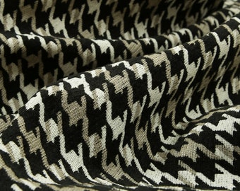 May include: Black and white houndstooth fabric with a textured woven pattern.