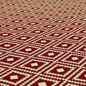 May include: Red and white woven rug with a geometric diamond pattern.