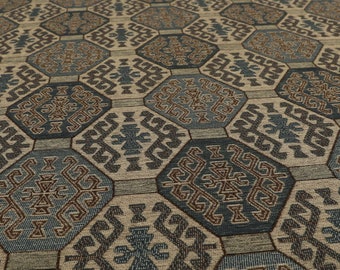 May include: Close-up of a patterned fabric with a geometric design in shades of brown, blue, and beige. The fabric features a repeating pattern of hexagons and squares.