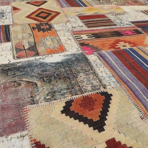 May include: A patchwork rug featuring a mix of colours and patterns, including red, blue, green, and yellow. The rug is crafted from various fabrics and textures, with visible seams. This rug is a great way to add a splash of colour and character to any room.