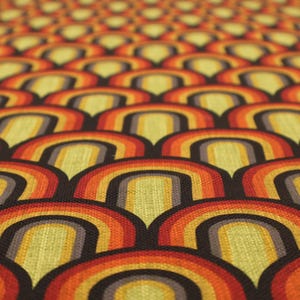May include: A close-up shot of a repeating pattern of retro arches in orange, yellow, and brown. The design has a textured look, creating depth. The overall theme is a vintage, 1970s aesthetic. The pattern is reminiscent of a rainbow.