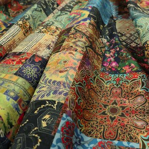 May include: A colourful fabric with a patchwork design featuring various patterns and colours, including blue, red, green, yellow, and brown. The fabric has a textured surface and a vintage aesthetic.