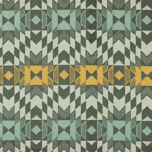 May include: A fabric with a geometric pattern in shades of green, blue, and yellow. The pattern features repeating shapes like diamonds, arrows, and squares.