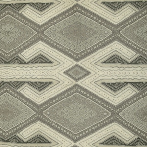 May include: A beige fabric with a geometric pattern in shades of brown and green. The pattern features repeating diamond shapes with intricate details.
