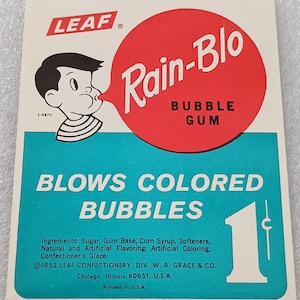 May include: Vintage Rain-Blo bubble gum wrapper. The wrapper features a cartoon boy blowing a bubble, with the text "Rain-Blo" in a red circle. The wrapper also states "Blows Colored Bubbles" and includes the number "1".