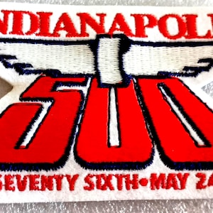 May include: Embroidered patch featuring the text "INDIANAPOLIS 500" in red and white, with a stylized wing design. The patch also includes the text "THE SEVENTY SIXTH • MAY 24, 1992" in red.