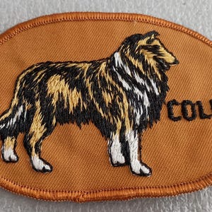 May include: Embroidered patch featuring a Collie dog in shades of black, gold, and white, set against a tan background. The word "COLLIE" is stitched in black. The patch has a brown stitched border.