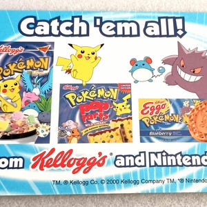May include: A promotional card featuring Pokémon characters and Kellogg's products. The card includes images of cereal boxes, Pop-Tarts, and Eggo waffles, all with Pokémon branding. The text "Catch 'em all!" is displayed at the top.