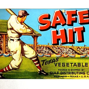 May include: Vintage baseball-themed advertisement with a baseball player swinging a bat. The words "SAFE HIT" are in large red letters. The text "Texas Vegetables" is also present, along with the Gulf Distributing Co. logo.