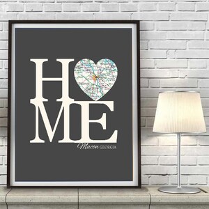 May include: A gray and white print with the word "HOME" in large white letters. A heart-shaped map of Macon, Georgia is in the center of the print. The text "Macon GEORGIA" is below the heart.