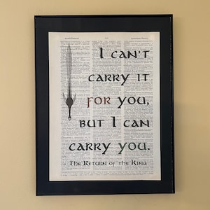 May include: A framed print of a dictionary page with a sword drawn through the page. The text on the page reads "I can't carry it for you, but I can carry you." The Return of the King.