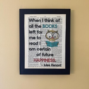 May include: A black framed print with a white background and black text. The text reads "When I think of all the BOOKS left for me to read I am certain of future HAPPINESS. - Jules Renard". An illustration of an owl with large glasses and a book is in the middle of the text.