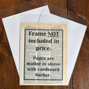 Pode incluir: Um recorte de jornal em preto e branco com o texto "Frame NOT included in price. Pages are mailed in sleeve with cardboard backer." O texto est&aacute; em negrito e em tamanho grande.
