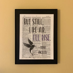 But still like air, I'll rise. _Maya Angelou printed on a dictionary page with an image of a hummingbird