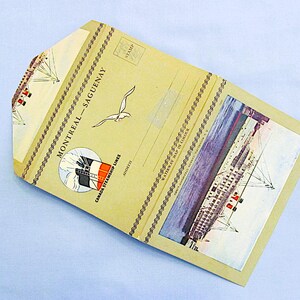 May include: A vintage postcard with a tan background and a picture of a ship on the water. The postcard has the text "Montreal - Saguenay" and "Canada Steamship Lines" printed on it.