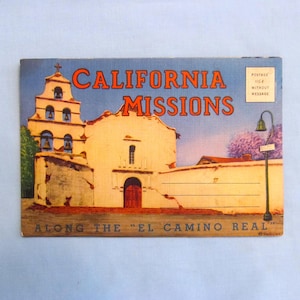 May include: A vintage postcard featuring a tan mission building with a bell tower, orange text reading CALIFORNIA MISSIONS, and the text ALONG THE EL CAMINO REAL. A small box in the corner reads POSTAGE 1 1/2 CENTS WITHOUT MESSAGE.