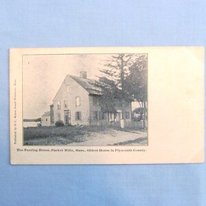 May include: A vintage black and white postcard featuring a photograph of The Fearing House in Parker Mills, Massachusetts. The text below the image reads: The Fearing House, Parker Mills, Mass., Oldest House in Plymouth County.