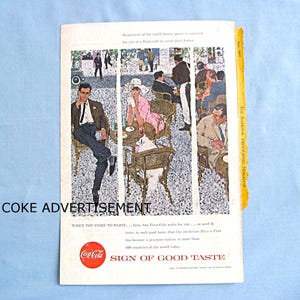 May include: Vintage Coca-Cola advertisement from The National Geographic Magazine. The illustration depicts people in a Parisian cafe setting. The ad includes the Coca-Cola logo and the text "Sign of Good Taste."