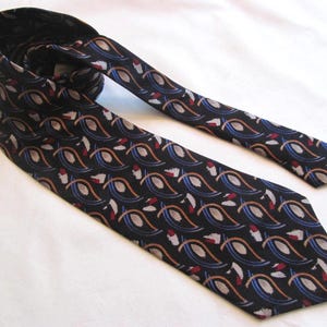 May include: A black necktie with a repeating paisley pattern in shades of blue, brown, red, and white. The tie is made of a smooth fabric and is suitable for formal or business attire.