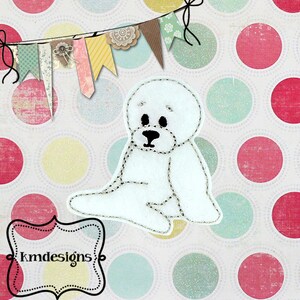 May include: A white felt seal applique with black eyes and nose, stitched with a contrasting thread. The seal is sitting on a background of colorful polka dots. A banner of decorative flags hangs above.