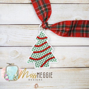 May include: Embroidered Christmas tree ornament with a green and white checkered pattern, red ribbon accents, and a white border. The ornament is attached to a red and green plaid ribbon. The design is from Miss Meggie Designs.
