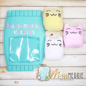May include: A turquoise blue felt pouch with a clear plastic window and the text "Marshmallow Kitties" embroidered on the front. Three felt cat toys in yellow, pink, and white are displayed in front of the pouch.