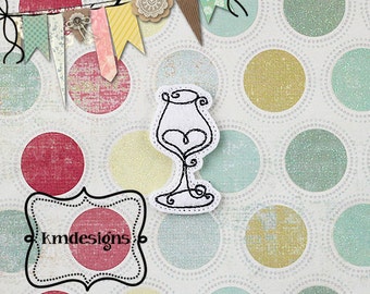 May include: A white wine glass with a black outline and a heart-shaped bowl, on a white background with a polka dot pattern in shades of red, yellow, blue, and green. The image also includes a banner with colorful fabric scraps and the text "kmdesigns".
