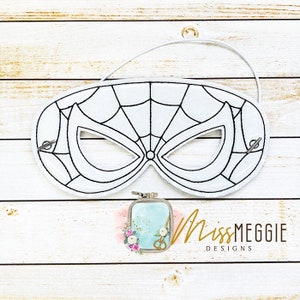 May include: A white felt mask with a black spider web design. The mask has a black elastic band for wearing.